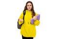 Photo of beautiful asking and having questions brunette teenage girl in stylish yellow sports hoodie with gray backpack Royalty Free Stock Photo