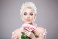 Photo of a beautiful blond woman with flower. Closeup attractive sensual face of white woman with curly hair. Smokey eye Royalty Free Stock Photo