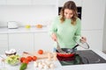 Photo of beautiful cheerful housewife watch frying pan checking mushrooms meal condition cooking tasty dinner lunch Royalty Free Stock Photo