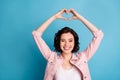 Photo of beautiful cheerful lady short black hairdo hold arms above head making heart figure shape dreamer express