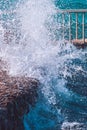 Photo of beautiful clear turquoise sea ocean water surface with ripples and bright splash on stone seascape background Royalty Free Stock Photo