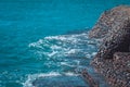 Photo of beautiful clear turquoise sea ocean water surface with ripples and bright splash on stone seascape background Royalty Free Stock Photo