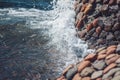 Photo of beautiful clear turquoise sea ocean water surface with ripples and bright splash on stone seascape background Royalty Free Stock Photo