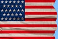 Photo of the beautiful colored national flag of the modern state of USA on textured fabric, concept of tourism, emigration, Royalty Free Stock Photo