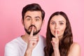 Photo of beautiful couple finger cover lips ask keep quiet secret wear casual outfit isolated pink color background