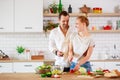 Photo of beautiful couple in love preparing breakfast in kitchen Royalty Free Stock Photo