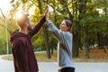 Photo of beautiful delighted couple giving fives while working out