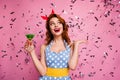 Photo of beautiful excited lady hold green cocktail theme retro party enjoy confetti falling prom queen wear red