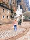 Beautiful Girl stands at the entrance to the old Orthodox Monastery Royalty Free Stock Photo