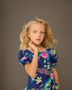 Photo of a beautiful Girl 7-8 years old in bright summer clothes with long blonde hair flying in wind. Concept of baby hair care, Royalty Free Stock Photo