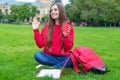 Photo of beautiful king cheerful excited funky person sitting on green grass waving palm enjoying summer drinking takeaway takeout