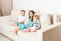 A photo of a beautiful little girl her two brothers sitting on the sofa. Royalty Free Stock Photo