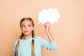 Photo of beautiful little lady holding white empty paper cloud deep thinking look empty space smart school girl wear Royalty Free Stock Photo