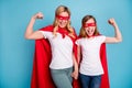 Photo of beautiful mom lady little daughter spend time together carnival super hero costumes showing strength muscles Royalty Free Stock Photo