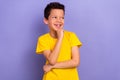 Photo of beautiful nice boy wear yellow stylish clothes interested look empty space offer poster isolated on purple Royalty Free Stock Photo