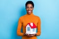 Photo of beautiful positive young male happy to own house moving modern apartment isolated on blue color background