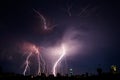 Photo of beautiful powerful lightning over big city, zipper and thunderstorm, abstract background, dark blue sky with bright