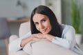 Photo of beautiful relaxed pretty calm young woman sit couch weekend rest dreamy mood home indoors in living room home Royalty Free Stock Photo