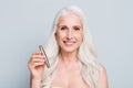 Photo of beautiful retired woman presenting new eyelashes recommendation isolated grey color background