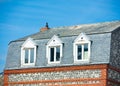 Photo of beautiful roof of one on the buildings on the wonderful sunny sky background