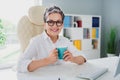 Photo of beautiful satisfied mature woman wear white formal shirt drink coffee waiting clients isolated on office window Royalty Free Stock Photo