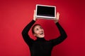 Photo of Beautiful smiling happy young brunette woman holding computer laptop with empty monitor screen wearing black