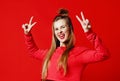 Photo of beautiful, smiling, positive girl showing peace symbol, looking at camera, posing on colorful background.