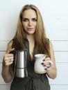 Beautiful woman holding Moka pot and coffee mug Royalty Free Stock Photo