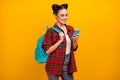 Photo of beautiful student lady hold telephone combine freelance work and study read job email wear blue bag casual Royalty Free Stock Photo