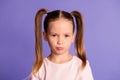 Photo of beautiful unhappy sad cute schoolgirl bad mood face isolated on purple violet color background