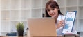 Photo of beautiful woman presenting her project with report  while sit looking  computer colleagues over modern meeting room Royalty Free Stock Photo