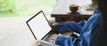 Photo of beautiful woman typing on white blank screen computer laptop that putting on her lap . Royalty Free Stock Photo