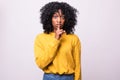 Photo of a beautiful young african woman showing silence gesture posing isolated over white wall background Royalty Free Stock Photo