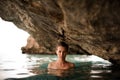 Beautiful young girl with redhead tied hair in the water cave Royalty Free Stock Photo