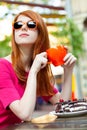 photo of beautiful young woman eating chocolate cake and drinking coffee in the cafe Royalty Free Stock Photo