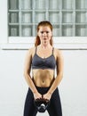 Beautiful young redhead exercising with a kettlebell