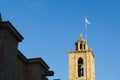 Photo of bell tower with Greek flag against blue sky Royalty Free Stock Photo
