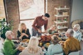 Photo of big family sit feast meals table around holiday roasted turkey father guy making slices hungry relatives