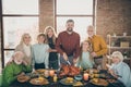 Photo of big family standing hugging feast table holiday roasted turkey making traditional portrait eight relatives