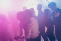 Photo of big group many people couple dance romantic atmosphere neon bright pink spotlight modern club indoors