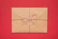 Photo of big package tied with striped red and white string ribbon isolated bright backdrop Royalty Free Stock Photo