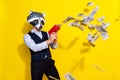 Photo of bizarre freak guy banker racoon mask shoot pistol salary money wear stylish look isolated over shine yellow