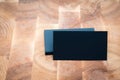 Photo of black blank business cards on wooden background. Template for ID. Top view Royalty Free Stock Photo