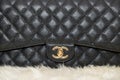 Photo of black Chanel handbag brand Editorial on white background. Royalty Free Stock Photo