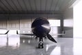 Photo of Black Matte Luxury Generic Design Private Jet parking in hangar airport. Concrete floor. Business Travel