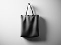 Photo black rubberized material bag hanging in center. Empty white wall background. Highly detailed texture, space for