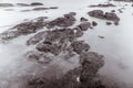 Photo Black and White of Long Exposure Photography Waves on stone beach waters edge abstract sea background.Thailand Royalty Free Stock Photo