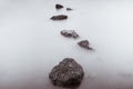 Photo Black and White of Long Exposure Photography Waves on stone beach waters edge abstract sea background.Thailand Royalty Free Stock Photo