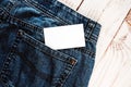 Photo of blank white business card sticking out of blue jeans pocket Royalty Free Stock Photo