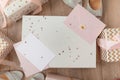 Photo of Blank white card in pink envelope isolated woodden color background with glitter stars, vaucher, gift certificate Royalty Free Stock Photo